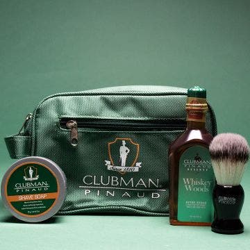 Clubman Shave Essentials Dopp Kit Bag flanked by Whisky Woods Shave Lotion, Shave Brush, & Shave Soap